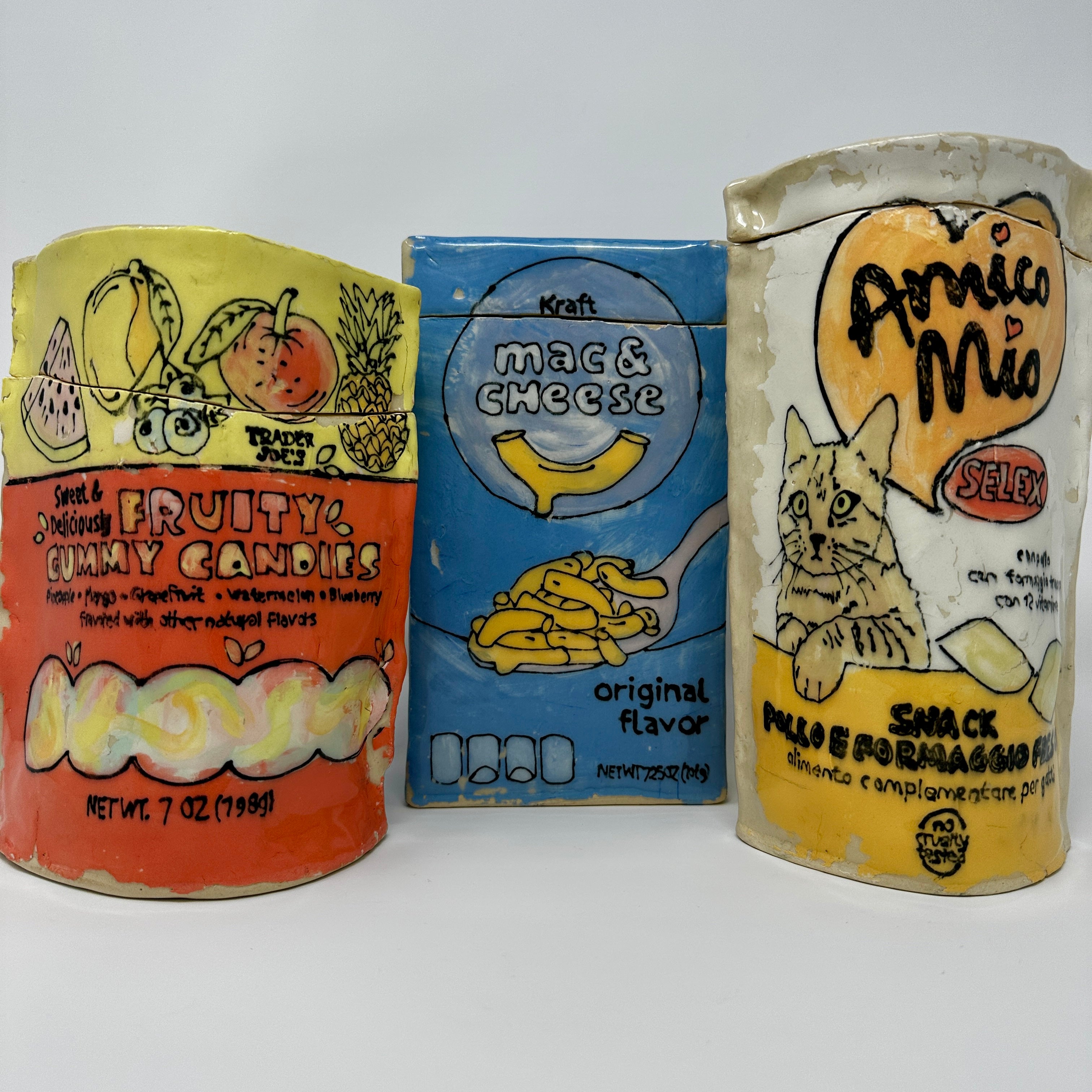 Three vintage food packaging containers with different designs on a white background