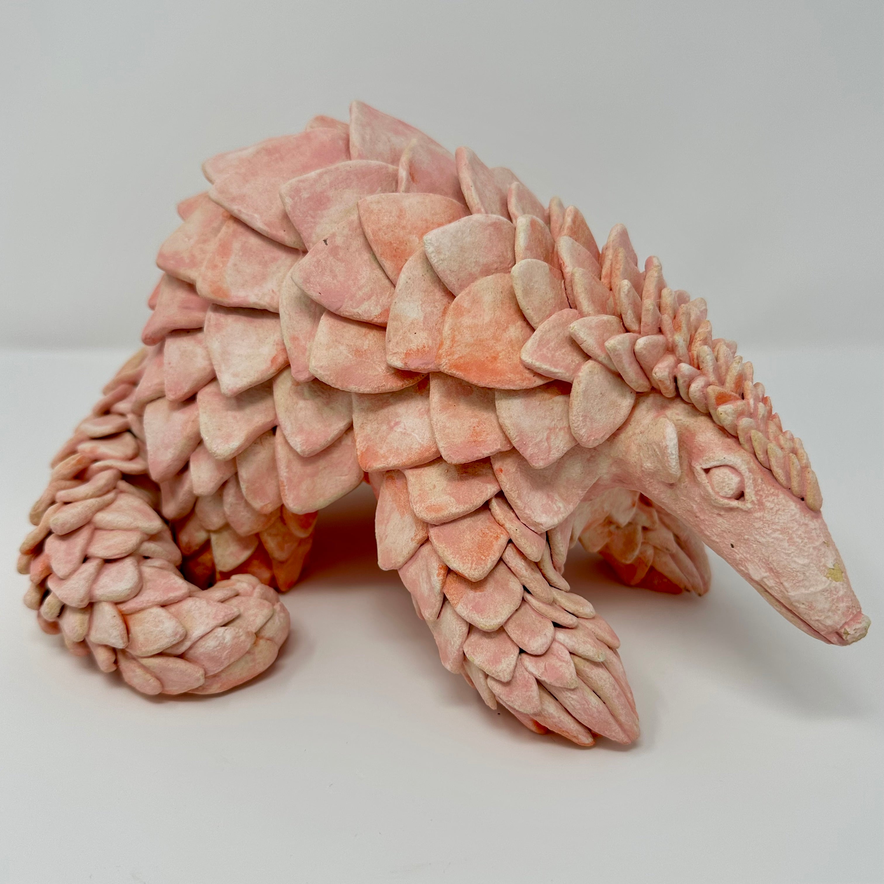 Sculpture of a pink ceramic pangolin